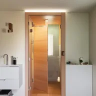 Compact and functional small bathroom designs carrying a door in the middle, equipped with modern fixtures, smart storage and efficient lighting