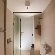 Compact and functional small bathroom designs carrying a door in the middle, equipped with modern fixtures, smart storage and efficient lighting