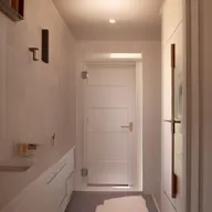 Innovative small bathroom designs featuring a central door, along with stylish fixtures, smart storage solutions, and good lighting