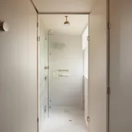 Innovative small bathroom designs featuring a central door, along with stylish fixtures, smart storage solutions, and good lighting