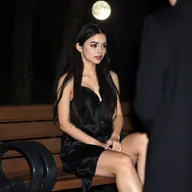 A full-length photographic image of a beautiful, innocent 18-year-old white girl seated on a bench in the dark moonlight within a quiet, secluded wooded park