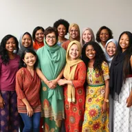 A diverse group of women from different backgrounds and cultures, standing together in a harmonious and empowering setting