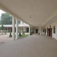 Generate an elegant image of a high-class school named 'GULSHAN-E-MILAT URDU HIGH SCHOOL' with modern infrastructure and a welcoming atmosphere.