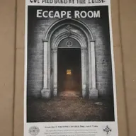 A poster advertising an escape room game, with a backdrop featuring a portal leading into a church.