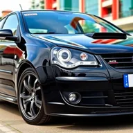 A sleek black Volkswagen Polo 9N3 from 2007, featuring striking BBS Montreal II wheels that enhance its sporty and elegant appearance