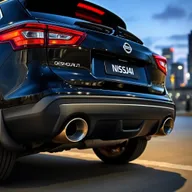 A striking black Nissan Qashqai J11 featuring two oversized exhausts, emphasizing its sporty and aggressive appeal